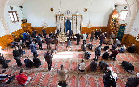ENSCHEDE, THE NETHERLANDS - FEB 13, 2015: Muslims are standing and bowing during the friday...