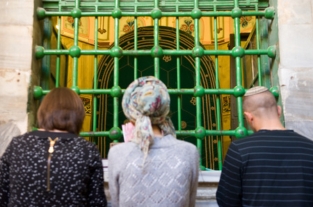 HEBRON, ISRAEL, 10 OCT, 2014: Three jewish people are praying in front of the tomb of patriarch Abraham. The tombs of the patriarchs are situated in the Cave of Machpelah in Hebronのeditorial素材