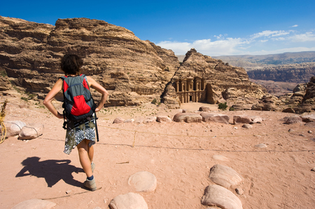 PETRA, JORDAN - OCT 12, 2014: A tourist is looking down from a hill to the Ad Deir monastery in Petra in Jordanのeditorial素材