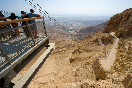 MASADA, ISRAEL - OCT 14, 2014: People enjoying the view from the arrival point of the cable car in Masadaのeditorial素材