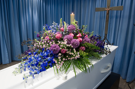 A coffin with a flower arrangement in a morgueの写真素材