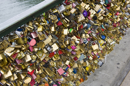PARIS, FRANCE - JULY 28, 2015: Thousands of padlocks on a fence near the Pont des Arts symbolize 'love forever' in Paris in Franceのeditorial素材