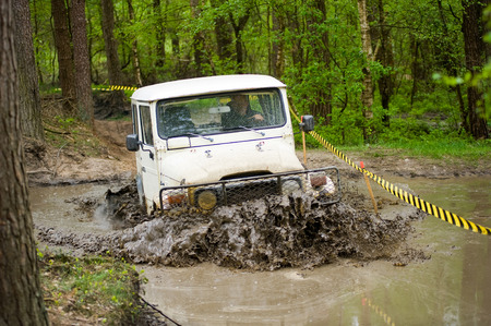 FURSTENAU, GERMANY - MAY 09, 2015: A jeep is driving through a pond of water on a special off the road terrain for land cruisers and vehicles in Germanyのeditorial素材