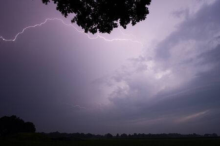 Thunder and lightning at the end of a hot and moistly summer day in the Netherlandsの写真素材