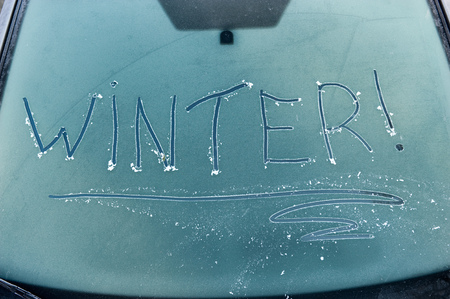 The word winter written on a frozen car windscreenの写真素材