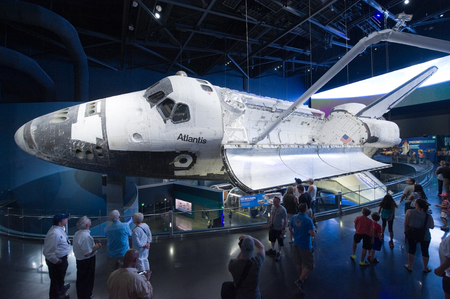 KENNEDY SPACE CENTER, FLORIDA, USA - APRIL 27, 2016: Visitors looking at Space Shuttle Atlantis which is exhibited at the visitor complex of Kennedy Space Centerのeditorial素材