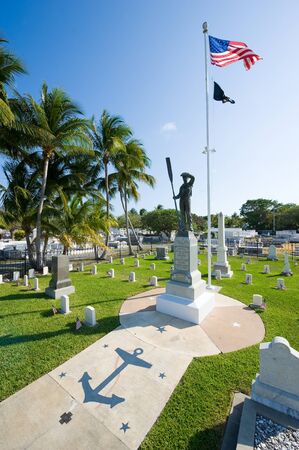 KEY WEST, FLORIDA, USA - MAY 02, 2016: Statue and American flag at the middle of the battleship Maine memorial section at the Key West cemetery.のeditorial素材