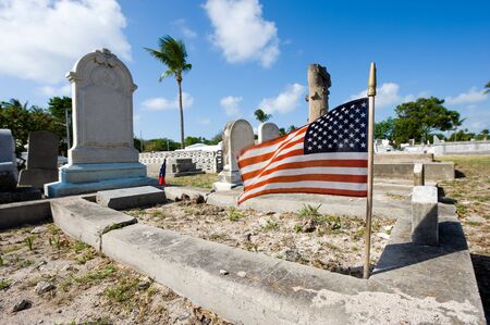 KEY WEST, FLORIDA, USA - MAY 02, 2016: American flag on a grave at the The Key West cemetery.It is a 19-acres cemetery, and about 100.000 people are buried here.のeditorial素材