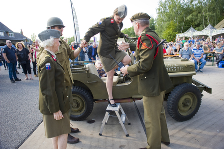 ENSCHEDE, THE NETHERLANDS - 01 SEPT, 2018: A singer from 'Sgt. Wilson's army show' stepping out of a jeep during a military army show.のeditorial素材