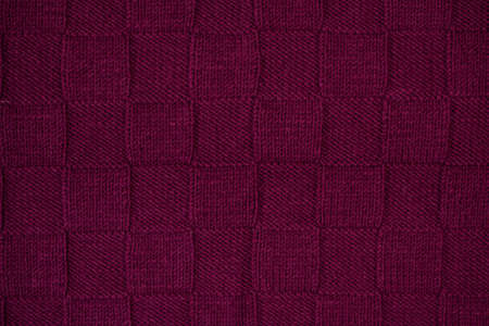 The texture of knitted canvas. Purple knitted plaid. Pattern squares, alternating front and reverse binding.の写真素材