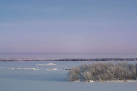 Winter landscape. Trees in hoarfrost, frozen river.