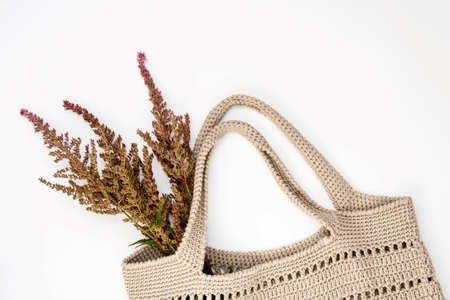 Autumn composition. Eco bag knitted and a bouquet of dried flowers astilba. View from above.の写真素材