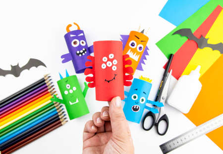 Halloween decoration. DIY and kids creativity concept. Step by step instructions: make a monster from a roll of colored paper toilet paper. Step 11 is the finished result.の写真素材