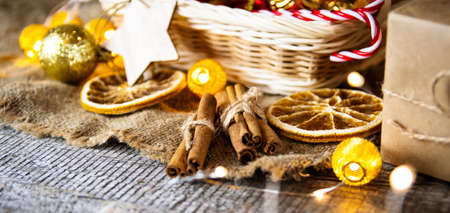 Christmas composition. Cinnamon sticks, dried orange on a wooden table.の写真素材