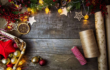 Flat lay packaging of Christmas gifts on wooden background. Copy space.