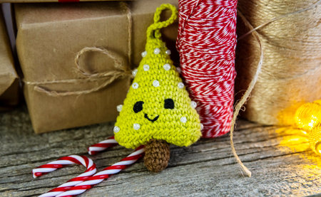 Crocheted herringbone on a wooden background. The concept of a cozy, magical Christmas and New Year.の写真素材