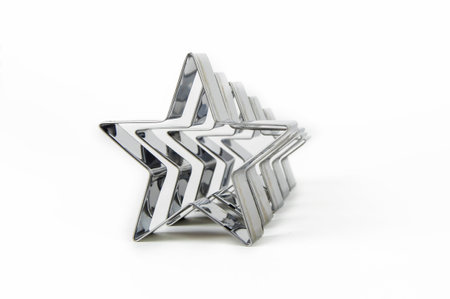Metal forms for cookies in the shape of a star on a white background in a row.の写真素材
