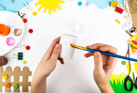 Crafts with children from toilet sleeves. Instruction step by step making farm animals: dog, cat, chicken, sheep, pig, horse. Step 1の写真素材