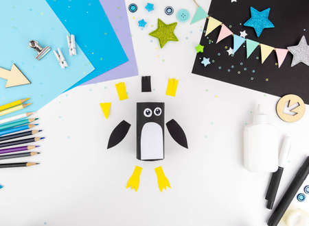 Step-by-step instruction of making a penguin out of paper with children.の写真素材
