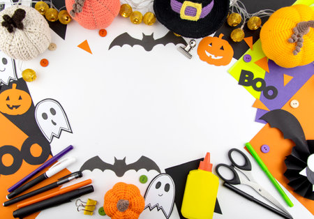 Halloween background top view of children's crafts, colored paper around the edges. Space for copying in the centerの写真素材