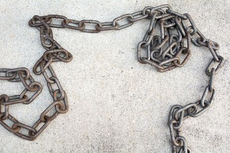 Old chain on cement floorの写真素材
