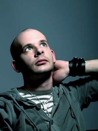 Low-key portrait about an attractive man with blue eyes who is looking up desires something