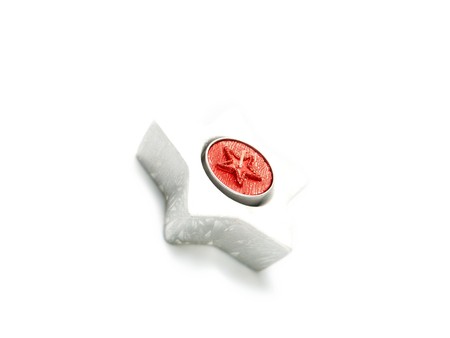 Nice closeup photo of a star shape Christmas ornament with a red candle. Isolated on white.の写真素材
