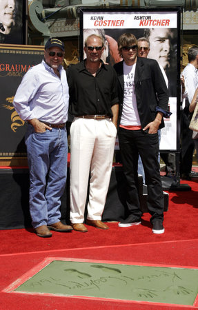 Andrew Davis, Kevin Costner and Ashton Kutcher at the Kevin Costner Hand and Footprints Ceremony held at the Grauman's Chinese Theater in Hollywood, California, United States on June 9, 2006.のeditorial素材