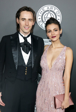 Victoria Justice and Reeve Carney at the Art Of Elysium's 11th Annual Heaven Celebration held at the Barker Hangar in Santa Monica, USA on January 6, 2018.のeditorial素材