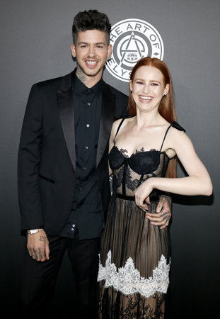 Madelaine Petsch and Travis Mills at the Art Of Elysium's 11th Annual Heaven Celebration held at the Barker Hangar in Santa Monica, USA on January 6, 2018.のeditorial素材