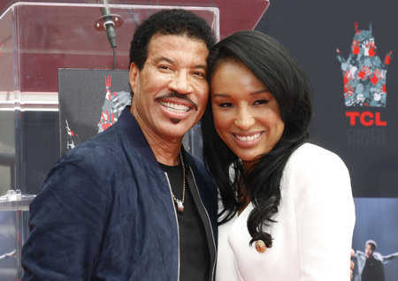 Lionel Richie and Lisa Parigi at Lionel Richie Hand And Footprint Ceremony held at the TCL Chinese Theatre in Hollywood, USA on March 7, 2018.のeditorial素材
