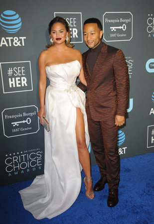 John Legend and Chrissy Teigen at the 24th Annual Critics' Choice Awards held at the Barker Hangar in Santa Monica, USA on January 13, 2019.のeditorial素材