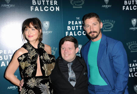 Dakota Johnson, Zack Gottsagen and Shia LaBeouf at the Los Angeles premiere of 'The Peanut Butter Falcon' held at the ArcLight Cinemas in Hollywood, USA on August 1, 2019.のeditorial素材