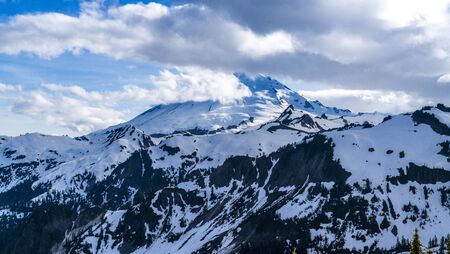 Mount Baker Glaciers. Washington, USA. Snowy peak through clouds seen from Artist Point.の写真素材