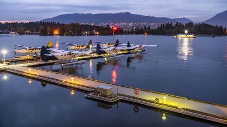 Seaplanes Sightseeing tours Vancouver, British Columbia, Canada. Docked seaplanes in harbor ready...