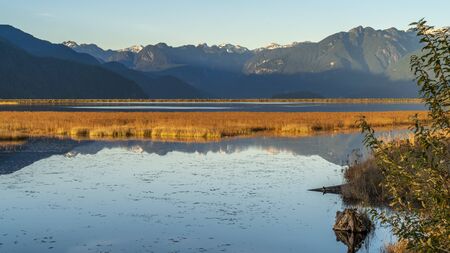 Vancouver, British Columbia, Canada. Fall colour reflected in the still waters of a Canadian Lake in a Provincial Park.の写真素材