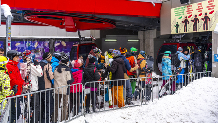 Poiana Brasov, Romania. 01. 03. 2019. People waiting in line to get into gondolas at a famous ski resort.のeditorial素材