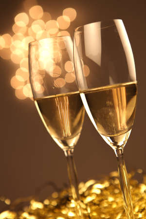Christmas glasses of Champagne and golden backgroundの写真素材