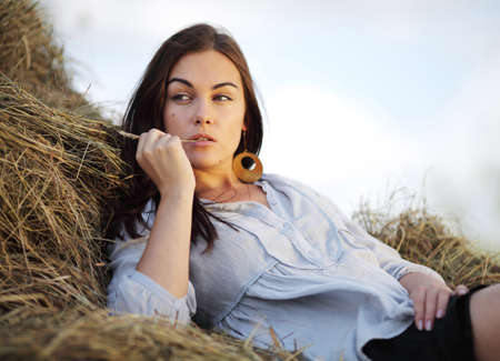 beautiful girl on stack of hayの写真素材