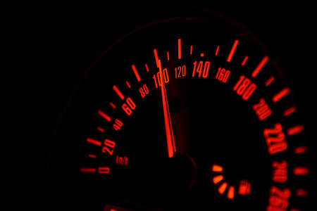 automobile speedometer on black background