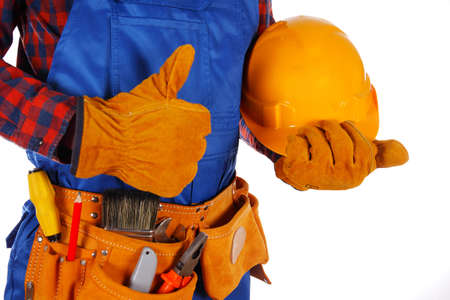 Handyman with helmet and workers belt full of tools isolated on white backgroundの写真素材
