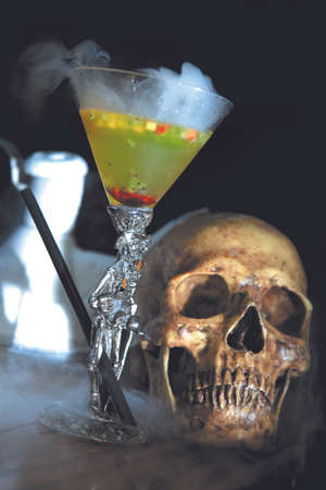 coctail with smoke and skull on a tableの写真素材