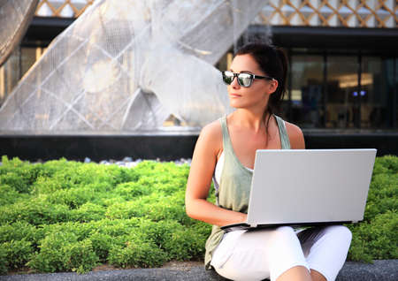 woman with laptop outdoorの写真素材