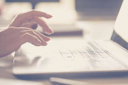 Closeup of a female hands busy typing on a laptop