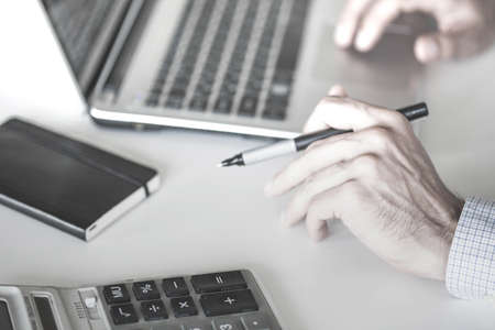 Closeup of a male hands busy typing on a laptopの写真素材