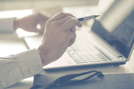 Closeup of a male hands busy typing on a laptop