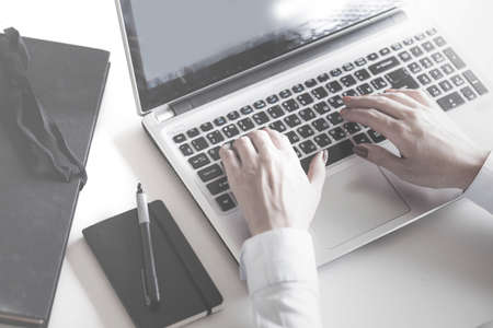 Closeup of a female hands busy typing on a laptop