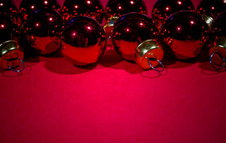 Red Christmas balls on red card background.の写真素材