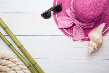 Vintage travel still life on old wooden fence with rope, starfish, compass, wooden signs and bottleの写真素材