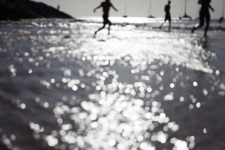 Blur people relax on tropical sunset beach and water bokeh. Abstactの写真素材